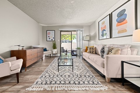 a living room with a white couch and a glass table